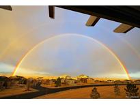 Beautiful view of a neighborhood with a double rainbow after the rain, creating a bright and cheerful scene at 5118 Bottlebrush Run, Broomfield, CO 80023