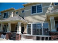 Charming townhome featuring a cozy front porch, perfect for relaxing and enjoying the neighborhood views at 16180 E Geddes Ln # 14, Aurora, CO 80016