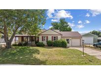 Charming single-Gathering home with a well-maintained lawn, mature trees and an attached garage at 7550 Raleigh St, Westminster, CO 80030