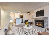 Bright living room featuring a fireplace, modern furnishings, and an open layout for easy entertaining at 6755 S Field St # 606, Littleton, CO 80128