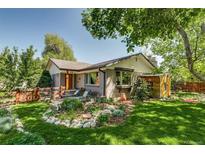 Charming home with a well-maintained front yard, lush lawn, and a cozy seating area at 3010 Zinnia Ct, Golden, CO 80401