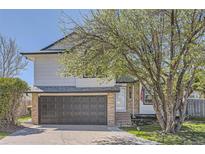 Charming home featuring a two-car garage and well-manicured landscaping with an inviting front entrance at 690 Howe Ct, Castle Rock, CO 80104