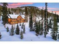 Luxury mountain home with stunning sunset views and snowy landscape at 699 Highlands Dr, Breckenridge, CO 80424