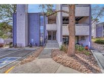 Exterior view of the condo complex with well-maintained landscaping and visible unit entrances at 6420 S Dayton St # J07, Englewood, CO 80111