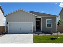Charming single-story home featuring a two-car garage and landscaped front yard under a clear blue sky at 2214 Alyssa St, Fort Lupton, CO 80621