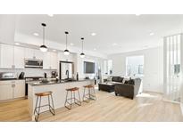 Modern kitchen with island, stainless steel appliances, and light wood cabinets at 3101 W 47Th Ave # 17, Denver, CO 80211