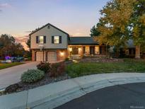 Charming two-story home featuring a well-manicured lawn and beautiful landscaping, creating an inviting curb appeal at 7668 S Locust St, Centennial, CO 80112