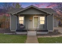 Charming home with inviting front porch, landscaped yard, and attractive exterior paint at 4478 S Acoma St, Englewood, CO 80110