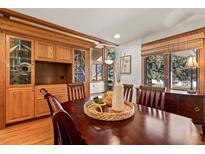 Inviting dining room featuring a custom built-in cabinet and a large window for natural light at 78 Fairway Ln, Littleton, CO 80123