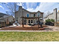 Enjoy the large backyard with a spacious deck, pergola, lounge area, and built-in fire pit at 270 S Locust St, Denver, CO 80224