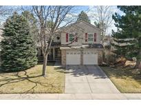 Charming two-story home with red shutters, a two-car garage and a manicured front yard at 270 S Locust St, Denver, CO 80224