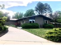 Charming one-story home with a brick exterior, mature trees, and a long driveway at 3001 S Vine St, Denver, CO 80210