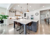 Bright, open kitchen featuring a large island with seating and modern pendant lighting at 493 Pine Flower Ct, Highlands Ranch, CO 80126