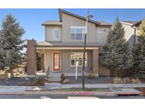 Charming two-story home with modern architecture, red front door, and landscaped front yard at 1622 W 67Th Ave, Denver, CO 80221