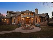 Stunning two-story brick home featuring a circular entryway and manicured front yard at 5 Redhawk Run, Cherry Hills Village, CO 80113