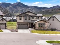 Two-story home with manicured front yard and mountain views at 3187 S Quaker St, Morrison, CO 80465