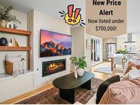 Inviting living room features a modern fireplace, television, and open layout to the kitchen at 1415 Irving St, Denver, CO 80204