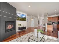 Inviting living room with fireplace, hardwood floors, and open floor plan at 2053 Meade St, Denver, CO 80211