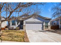 Charming single-Gathering home with a well-manicured lawn, mature trees, and a two-car garage and a neutral color scheme at 18315 E Amherst Dr, Aurora, CO 80013