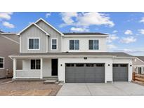 Charming two-story home featuring a three-car garage and covered porch at 39152 Clymer St, Elizabeth, CO 80107