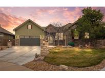 Charming home with stone accents, lush lawn, and a welcoming entrance in a serene, landscaped setting at 7178 Galaxy Ct, Castle Rock, CO 80108