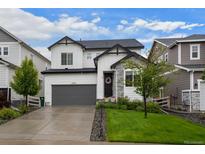 Charming two-story home with a gray garage door, stone accents and a well-manicured lawn at 5223 Gray Wolf Ln, Castle Rock, CO 80104