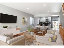 Bright living room with updated decor flowing into open kitchen and dining area at 6400 E Mississippi Ave, Denver, CO 80224