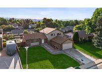 Charming home boasts a lush lawn, mature trees, and inviting curb appeal in a desirable neighborhood at 7351 S Marion St, Centennial, CO 80122