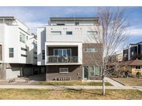 Modern three-story home with a balcony and rooftop deck, showcasing contemporary design elements at 3145 W 19Th Ave, Denver, CO 80204