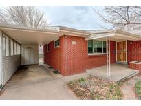 Charming single-story red brick home with a covered car port and well-maintained yard at 2885 S Gilpin St, Denver, CO 80210