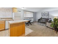 Open-concept living room and kitchen area with hardwood flooring and contemporary furnishings at 1260 N Humboldt St # 1, Denver, CO 80218