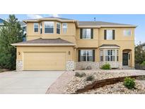 Charming home with a two-car garage, stone accents, bay windows, and nicely landscaped front yard at 13262 Elizabeth St, Thornton, CO 80241