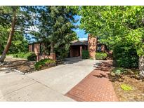 Charming single-story brick home featuring mature trees, landscaped yard, and a driveway at 5401 E Dakota Ave # 22, Denver, CO 80246