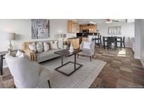 Living room with gray sofa, decorative pillows, area rug, and an open floor plan to the kitchen at 909 N Logan St # 11A, Denver, CO 80203