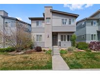 Charming two-story home with modern design, landscaped front yard, and concrete entry steps at 9624 Dunning Cir, Highlands Ranch, CO 80126