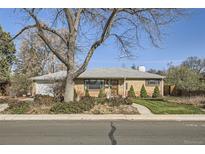 Charming brick home with well-maintained front yard and mature landscaping, plus an attached one car garage at 2070 Kingston St, Aurora, CO 80010
