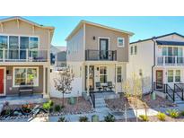 Charming two-story home featuring a balcony and a cozy front porch with seating area at 18284 E 49Th Pl, Denver, CO 80249