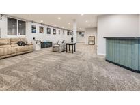 Finished basement with seating area and bar at 846 S Sheridan Blvd, Denver, CO 80226