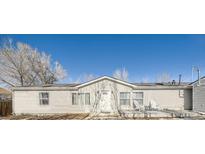 Ranch style home with light-colored siding, a small porch, and mature trees at 846 S Sheridan Blvd, Denver, CO 80226