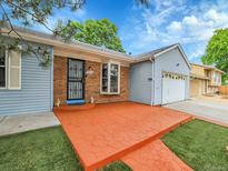 Charming single-story home featuring a brick facade, red walkway, and a well-maintained lawn at 9423 Brentwood St, Broomfield, CO 80021