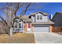 Charming two-story home featuring a well-maintained front yard and a gray painted facade and attached two-car garage at 176 S Pembrook St, Castle Rock, CO 80104