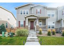 Two-story townhome with front porch and landscaping at 4343 S Nepal Ct, Centennial, CO 80015