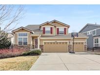 Charming two-story home with a three-car garage and a well-maintained front yard and attractive stone accents at 6296 S Rifle St, Aurora, CO 80016