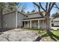 Inviting front exterior with a charming covered porch and decorative landscaping at 12622 E Warren Dr # E, Aurora, CO 80014