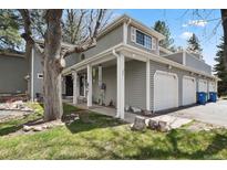Charming home featuring a two-car garage, covered porch, and meticulously maintained lawn at 12622 E Warren Dr # E, Aurora, CO 80014
