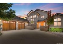 Stunning two-story home featuring stone accents, a three-car garage, and beautiful landscaping at 2416 Fossil Trace Dr, Golden, CO 80401