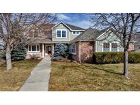 Inviting two-story home with a well-manicured lawn and charming front porch at 3188 Soaring Eagle Ln, Castle Rock, CO 80109