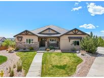 Inviting single story home with stone accents, manicured lawn, and well-maintained landscaping at 9510 Orion Way, Arvada, CO 80007