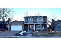Charming two-story home with attached two car garage and landscaped front yard at 7313 S Costilla St, Littleton, CO 80120