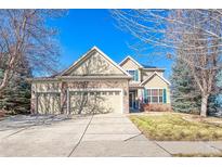 Charming two-story home with a three car garage, stone accents, manicured lawn, and traditional architecture at 1775 W 130Th Pl, Westminster, CO 80234